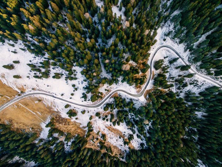 aerial-view-of-snowy-forest-with-a-road-captured-f-PAUZRF7.jpg